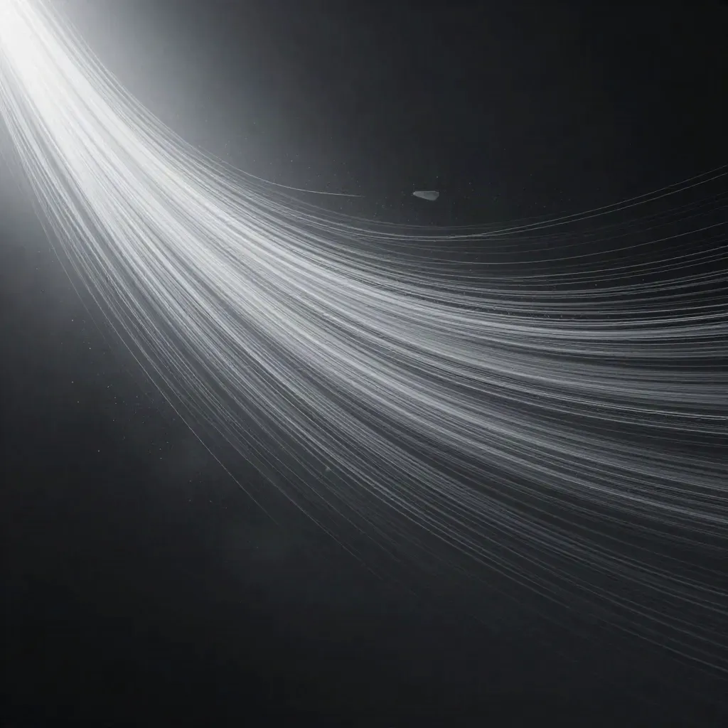 Silver filaments converge into a white bloom in graphite haze, with drifting motes.